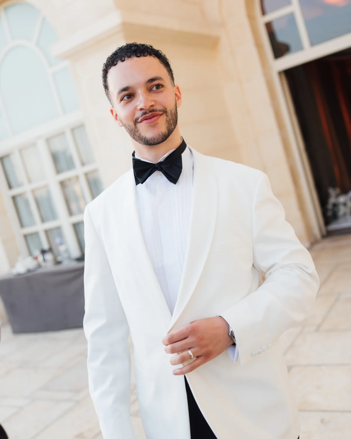 Elias Bennett smiling in a white dinner jacket