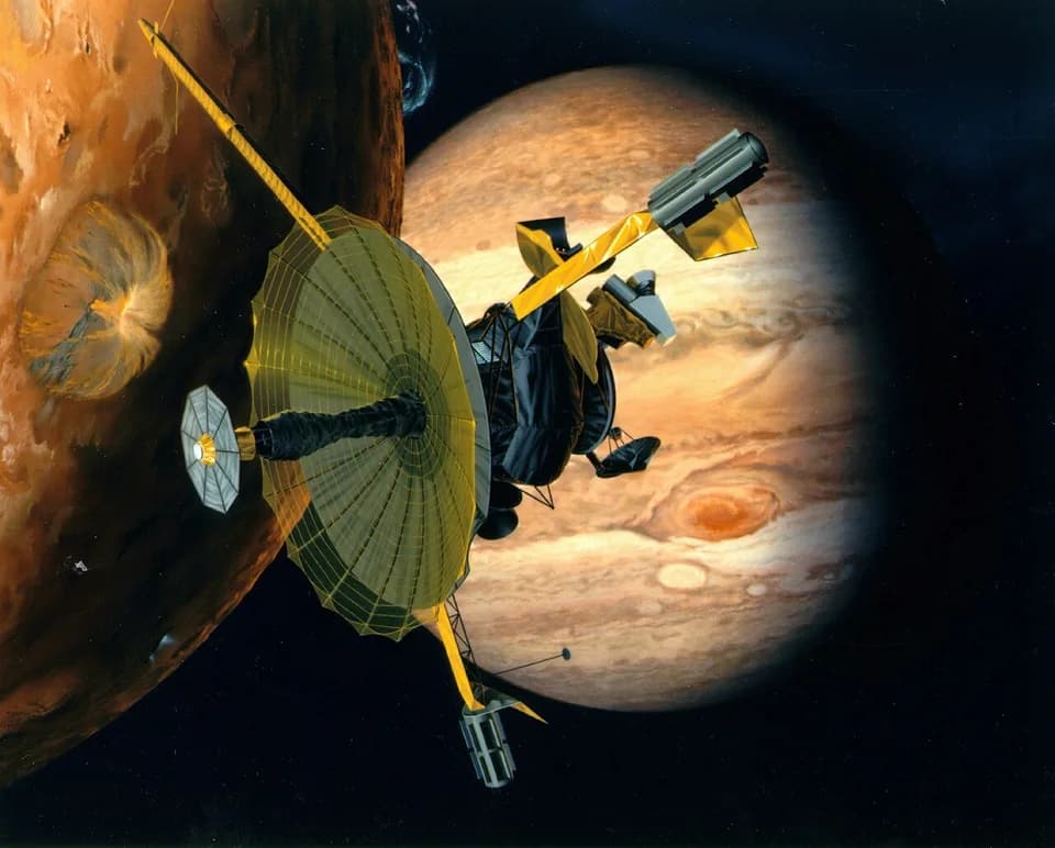 NASA illustration of the Galileo spacecraft passing Io, with Jupiter behind it